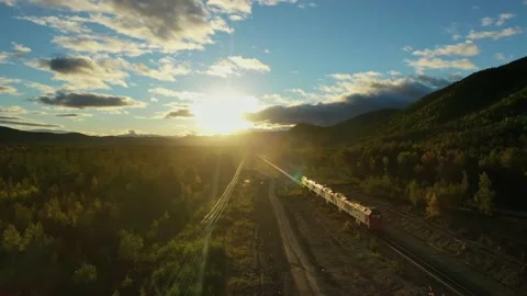 Train leaves into sunset drone video. 4K Stock Footage 235818840