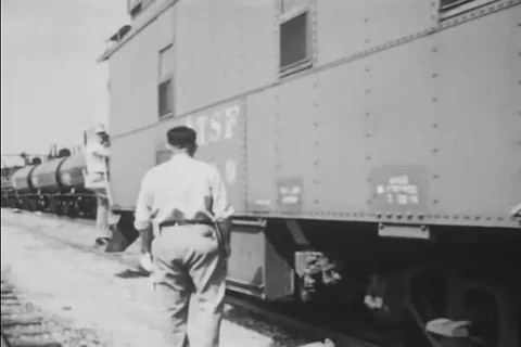 A train leaves a train yard and the engineer and conductor do their jobs Stock Footage 92634935
