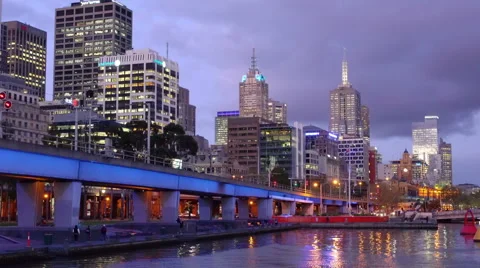 Train leaving CBD of a city at sunset Stock Footage 56154988