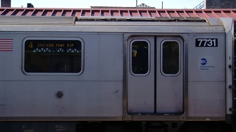 Train leaving MS Fordham road sign people going by Stock Footage 87055940