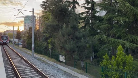 Train leaving the platform, evening light- stock video Stock Footage 240342044