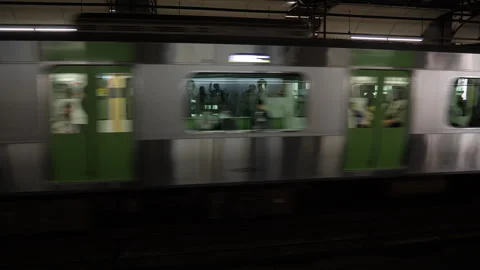 Train leaving, revealing station platform. Tokyo, Japan. Stock Footage 246797140