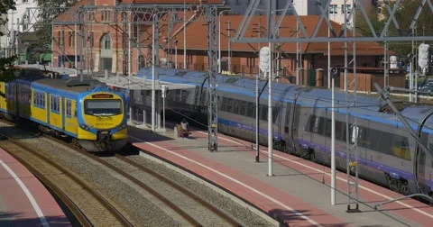 Train is Leaving The Station Blue And Yellow Passenger Electric Train is Stock Footage 55293302