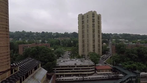 Train leaving station in a city Stock Footage 76893294
