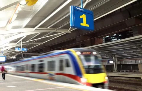 Train leaving station platform number one Stock Photos