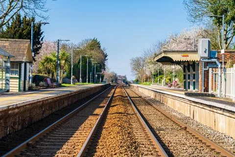 Train line and small train station in the UK during Spring Stock Photos