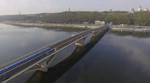 Train in Motion at The Metro Bridge through the Dnipro river in Kiev. Aerial Stock Footage 57381952