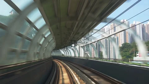 Train moves along metro or subway railroad tunnel and passes by Hong Kong city Видео 89807018