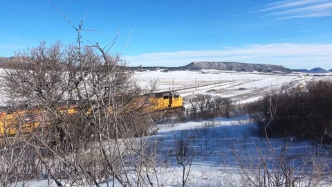 Train moves left to right through morning winter landscape Stock Footage 105190826