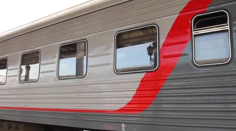 Train moves on the railway junction. In the windows of cars reflected lights Stock-Footage 64636163
