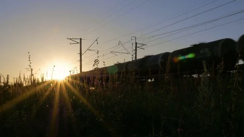 The train moves through beautiful sunlight. Video stock 80036681