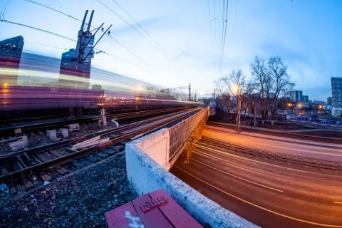 Train moving along platform in twilight  Stock Photos