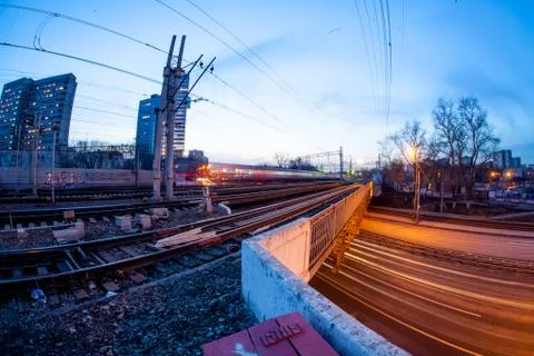 Train moving along platform in twilight  Stock Photos
