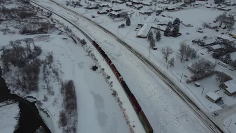 Train moving along small town in winter Stock-Footage 310528742