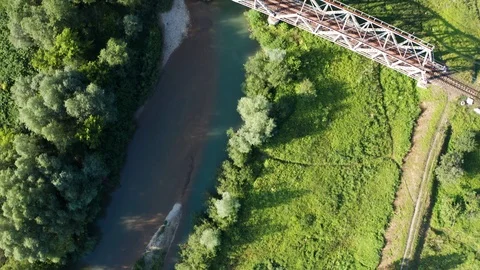 Train moving on bridge above a river Video stock 112737576