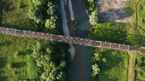 Train moving on bridge above a river Video stock 112737853