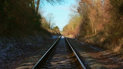 Train moving forward along railway tracks through forest corridor first person Stock Footage 328359075
