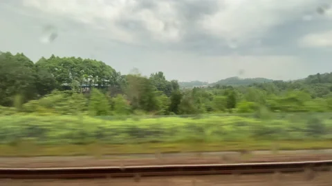 Train moving forward motion through window rain water Kuala Lumpur Malaysia Stock Footage 132548456