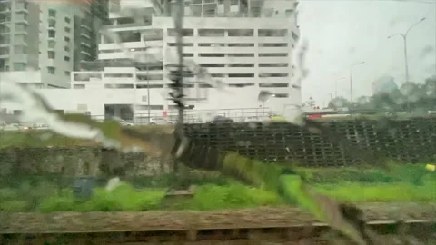 Train moving forward motion through window rain water Kuala Lumpur Malaysia Stock Footage 132548729
