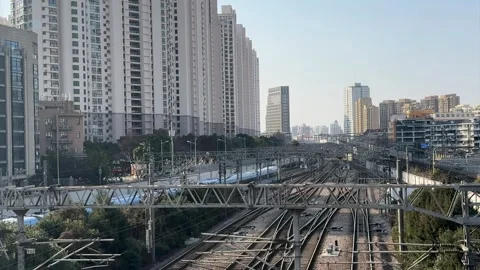 Train Moving Forward on Railway Tracks in Modern City Stock Footage 331899569