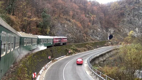 Train moving on mountain slopes and enters tunnel Stock Footage 101175638