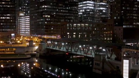 Train moving over the illuminated Lake Street Bridge, night in Chicago, USA Stock Footage 255630898