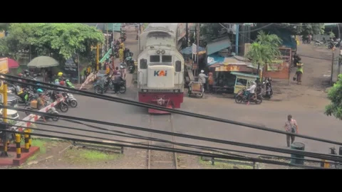 A train that is moving passes under the building Stock Footage 290770571