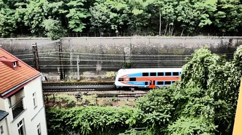 Train moving past behind building Stock Footage 68094900