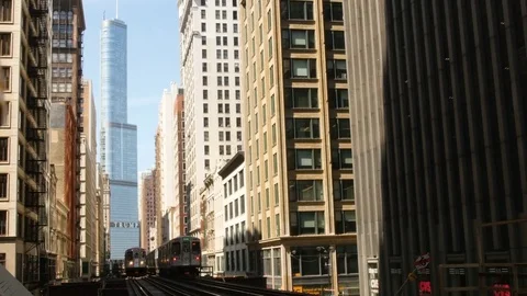 Train moving on railway track between amidst high rise building Stock Footage 81617560
