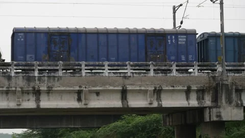 Train moving right to left in bridge in slow motion Stock Footage 225739368