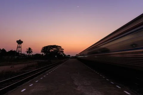 Train moving to the station in sunset Stock Photos
