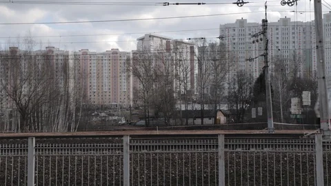 The train is moving through the city, side view, high-rise apartment buildings Video stock 128066145