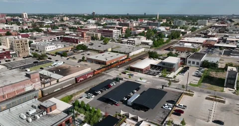 Train moving through an older business section downtown Oklahoma City Stock Footage 335674281
