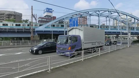 Train moving through Overpass Bridge in Yokohama Stock Footage 255056089