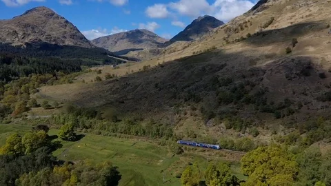 Train moving through Scottish highlands Stock Footage 108569001