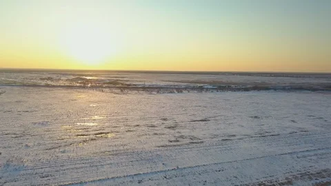 The train is moving through snow covered fields at sunset Stock Footage 123101683