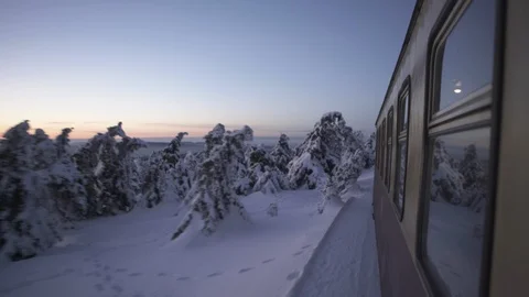 Train moving through snowy landscape Stock Footage 116195025