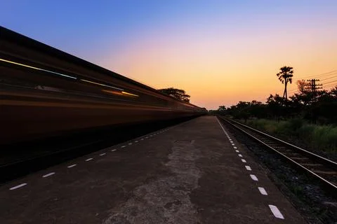 Train moving through the station in the  sunset Stock Photos