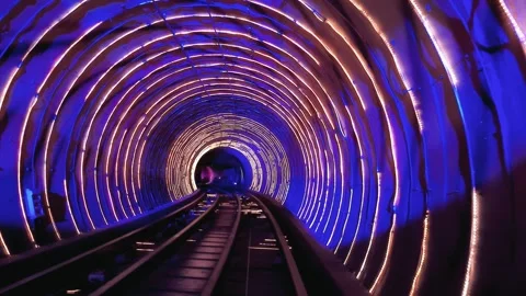 Train moving through tunnel with psychedelic lights animations at night in Sh Video stock 276658865