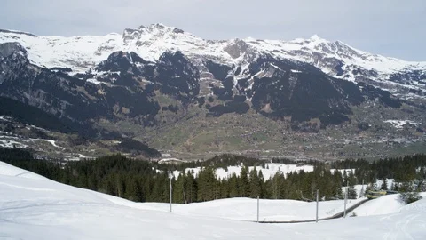 Train moving through the valley of the Swiss Alps in winter Stock Footage 113238374