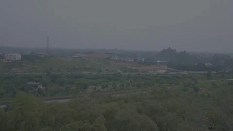 Train moving on the track between the city and forest at morining time Stock Footage 221115080