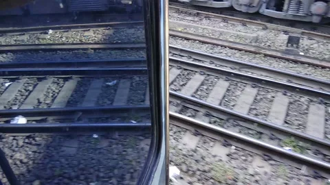 A train moving on tracks with reflection in door of carriage Stock Footage 113495117