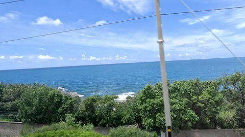 The train is moving. The view from the train is of the sea and the landscape  库存影片 329488377