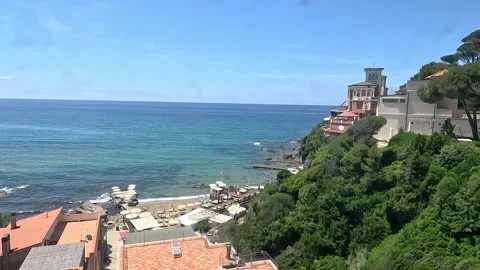 The train is moving. The view from the train is of the sea and the landscape  Stockbeeldmateriaal 329505508