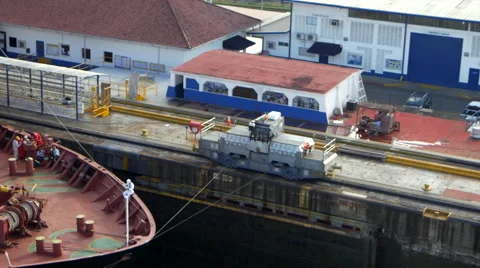 Train mules pulling cargo ship through Gatun lock of Panama Canal, Panama Stock Footage 51479515