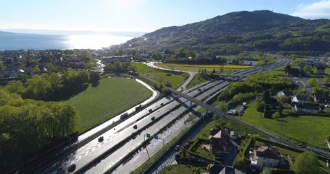 Train MVR approaching highway in St-Légier - Aerial 4K Stock Footage 107042784