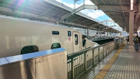 Train operator leaning out of high speed train during departure Stock Footage 335214553