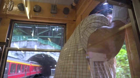 A train operator looking through a window 스톡 동영상 98655692