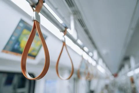 Train passenger standing handle hook on the railing bar, using to gripping fo Photos