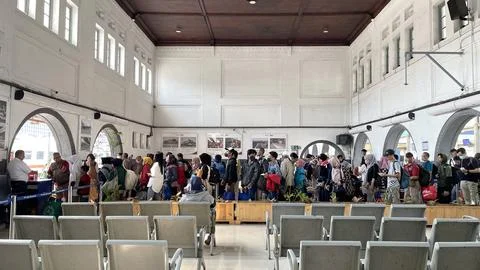 Train passengers queue to enter the train departure waiting room Stock Photos